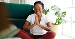 Woman practicing yoga and meditation at home