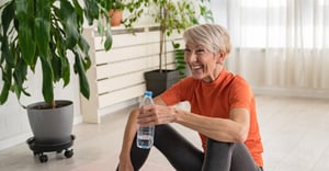 Senior woman working out and drinking water