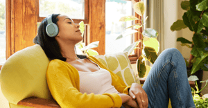 Woman relaxing listening to music on a chair