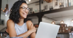 Remote worker on computer at coffee shop